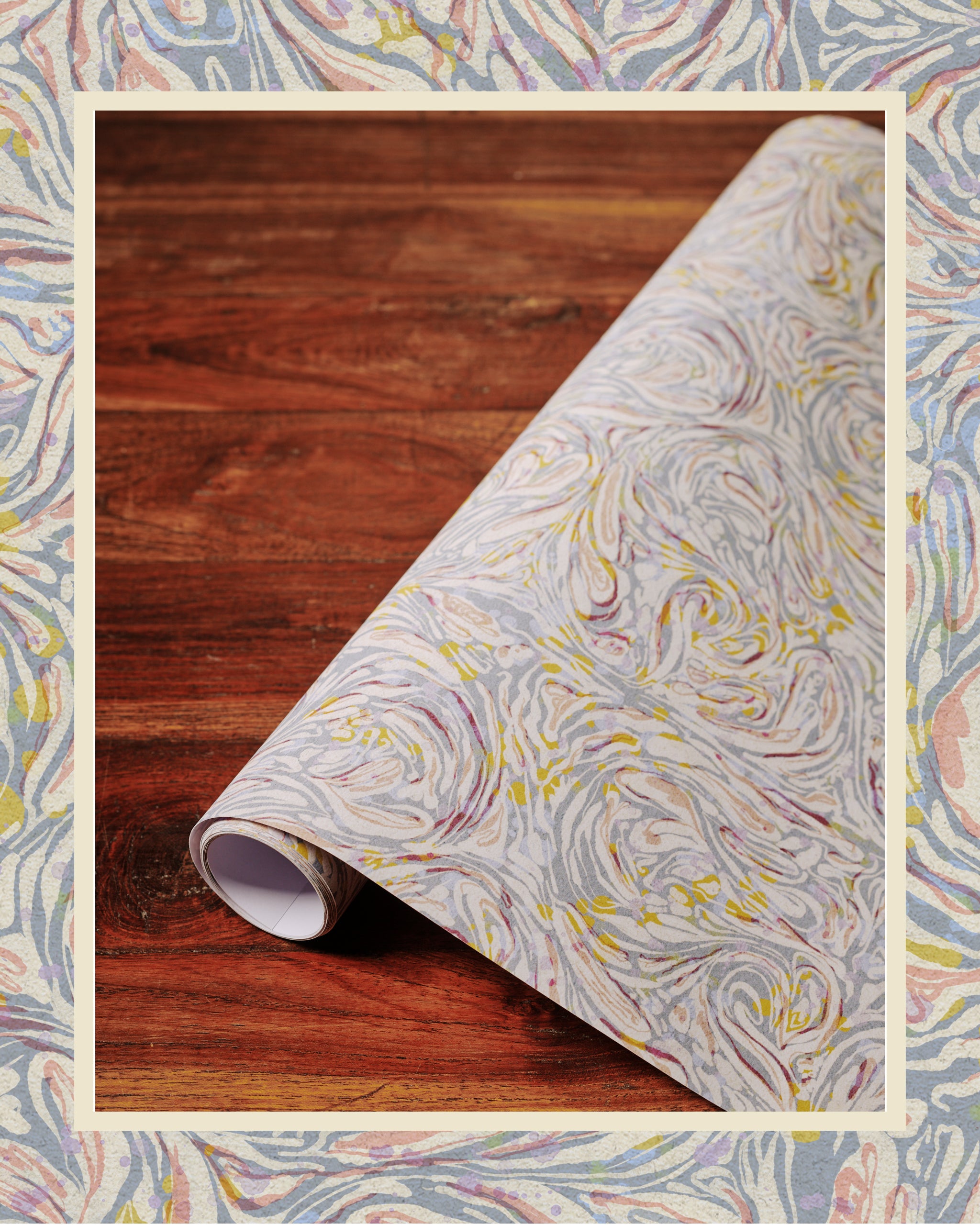 A roll of marble patterned lavender-colored paper laid out on a wooden surface.
