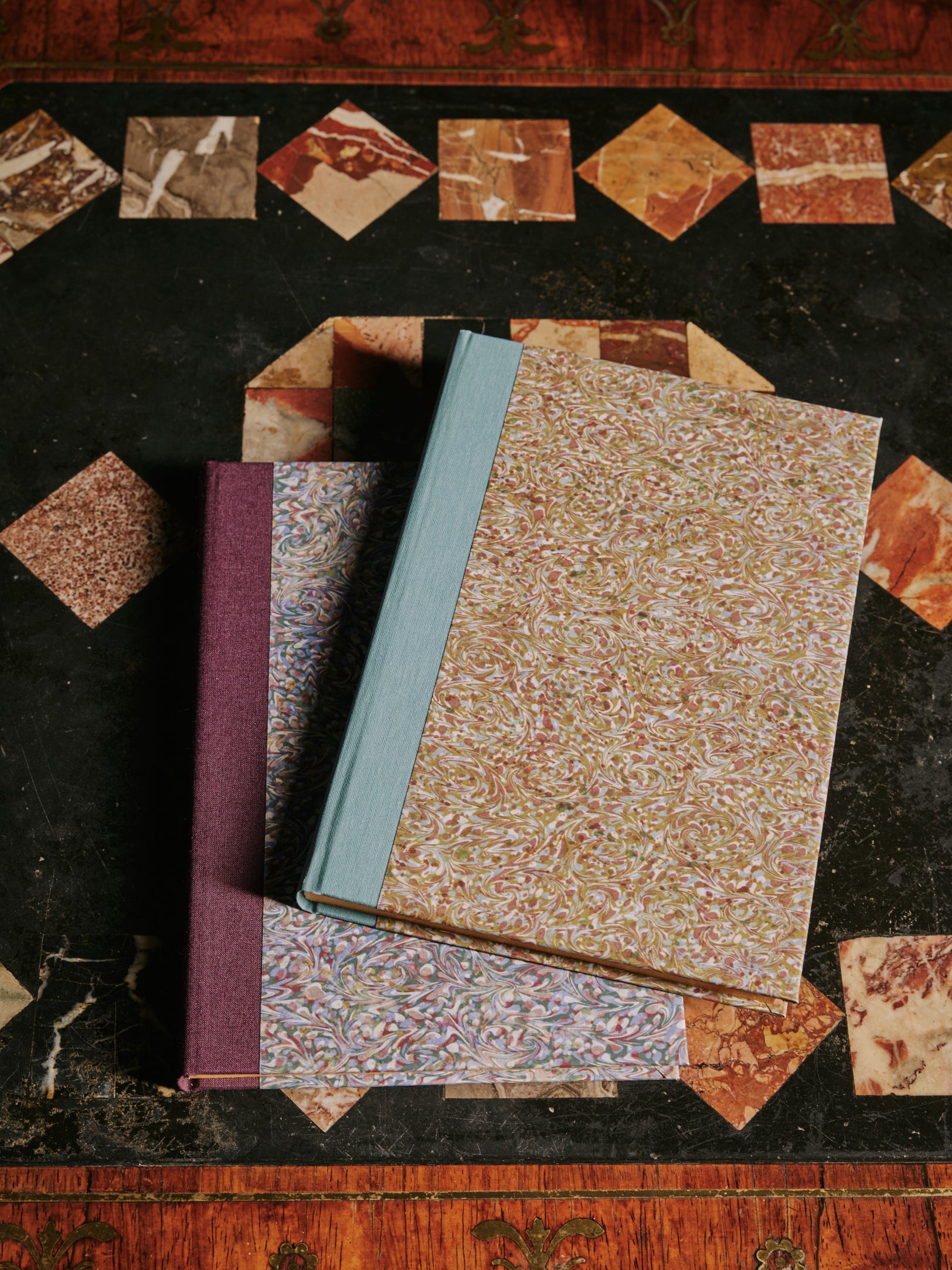 a group shot of The Kensington Paperie marble spinelli zaffo notebook