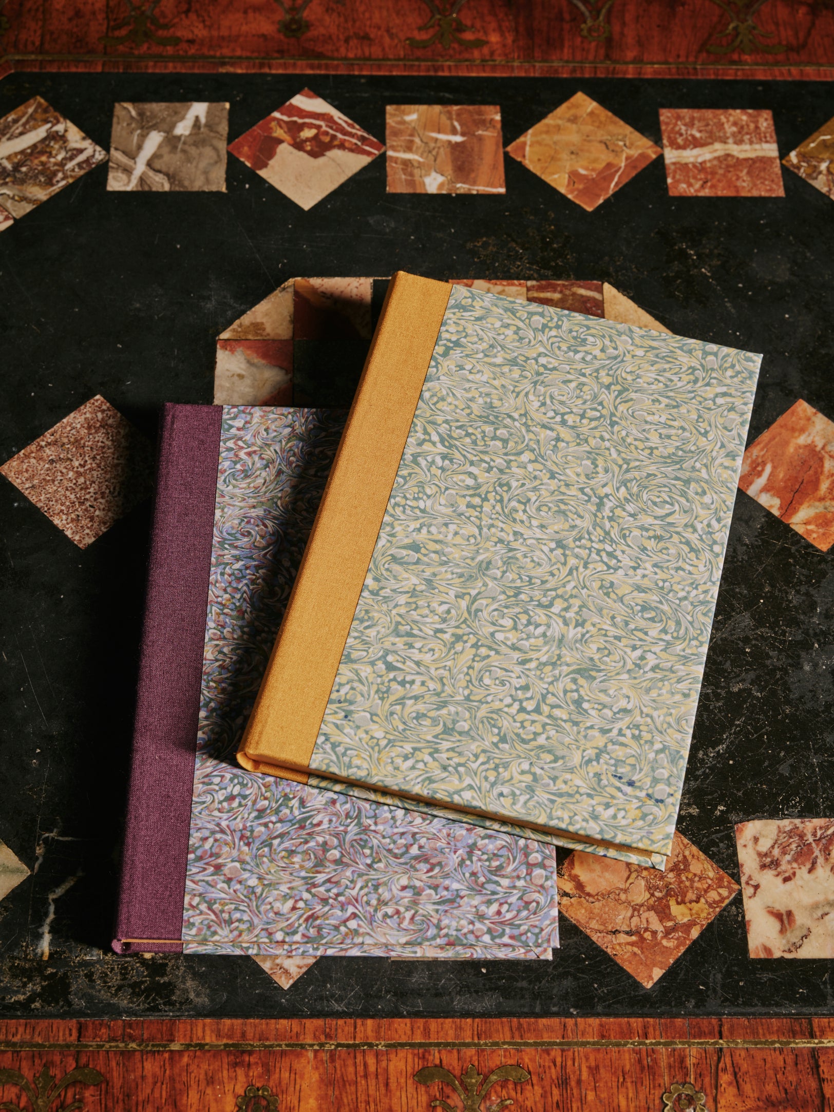 a group shot of The kensington Paperie marble tiepolo notebook product