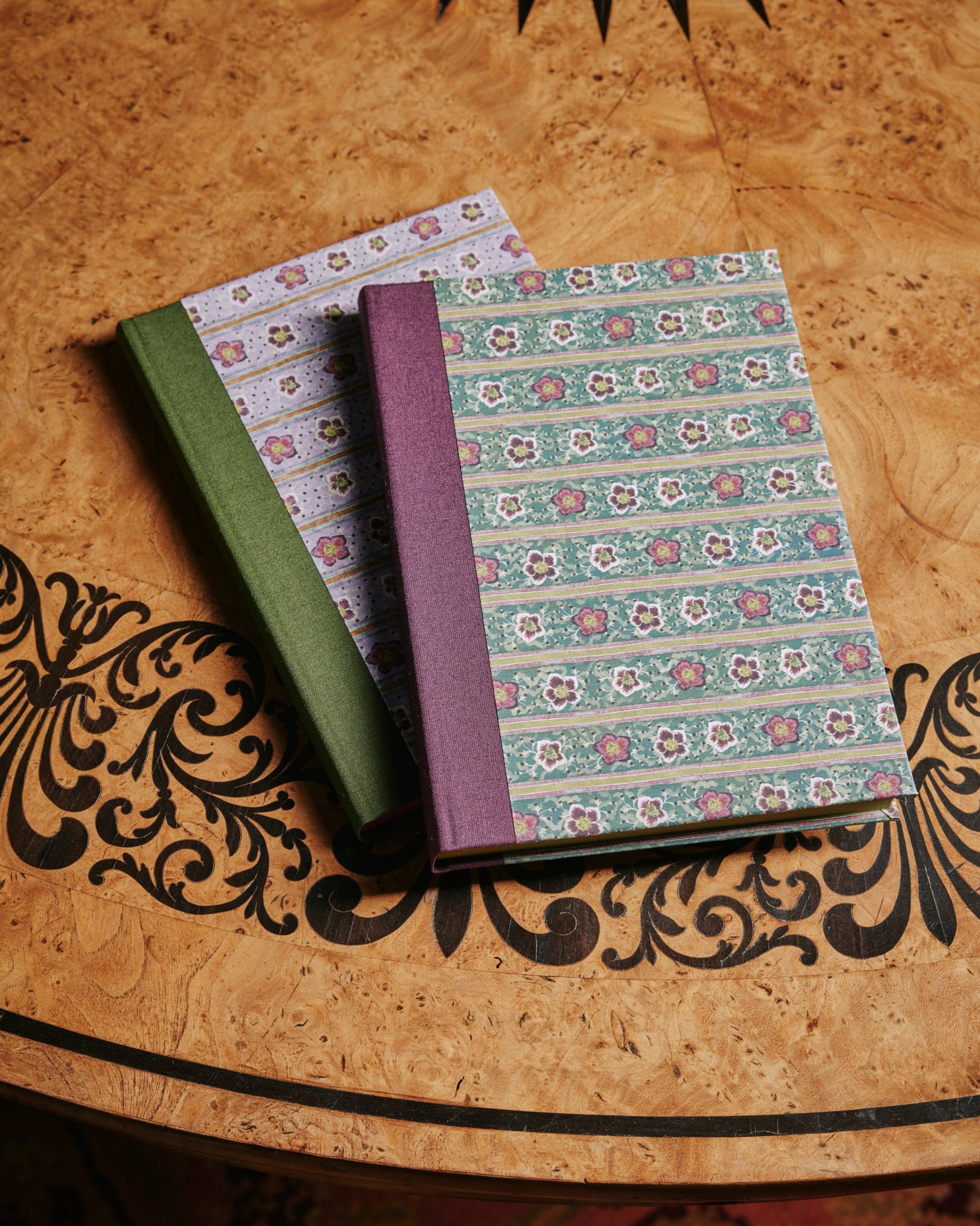 a group shot of The kensington Paperie winter rose notebook product
