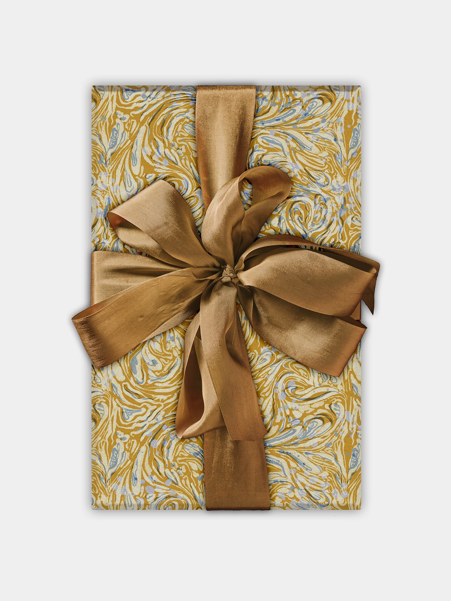 A roll of wrapping paper with a mustard yellow and blue marbled pattern, presented with a gold ribbon bow.