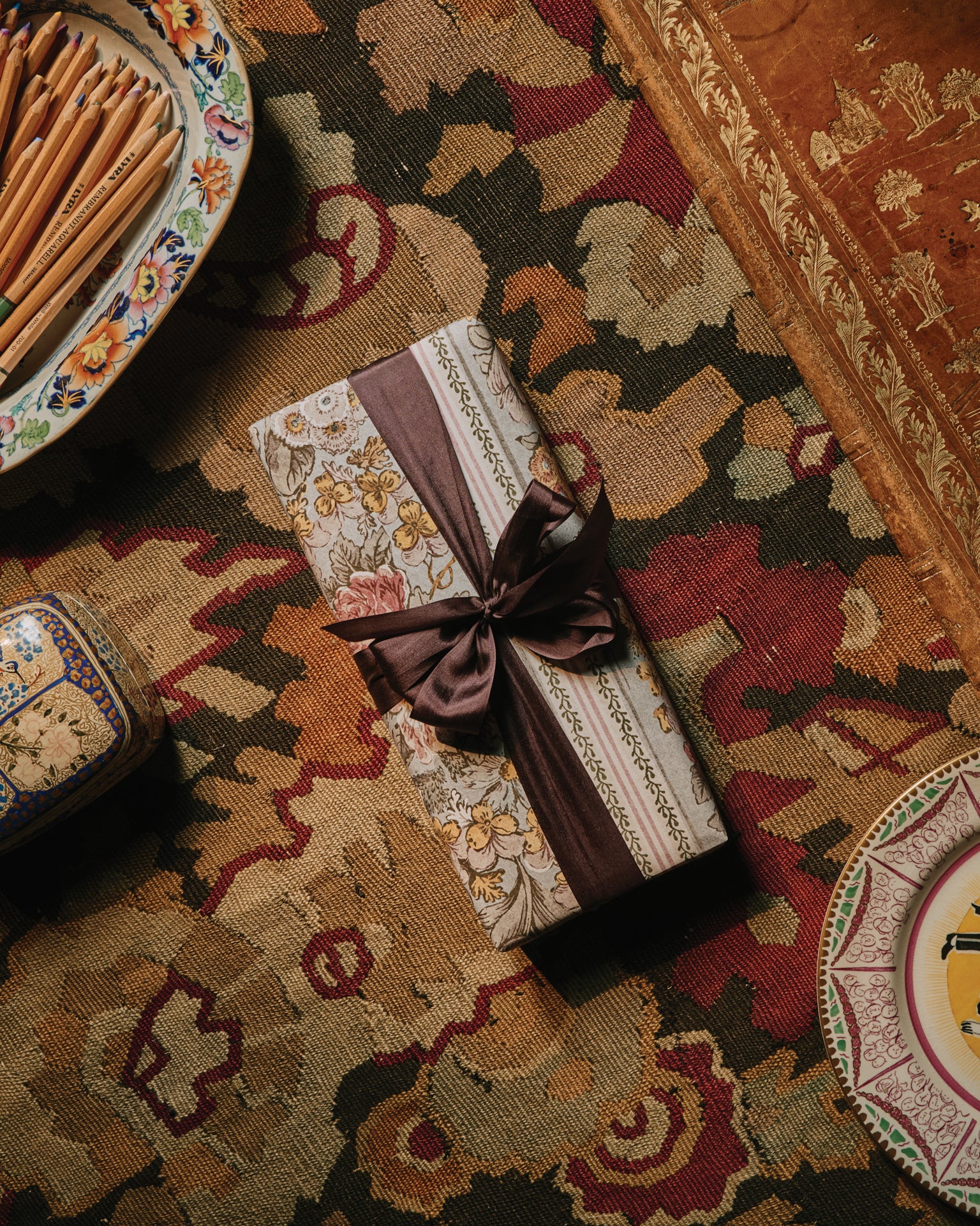 A gift wrapped in The Kensington Paperie wrapping paper on a table