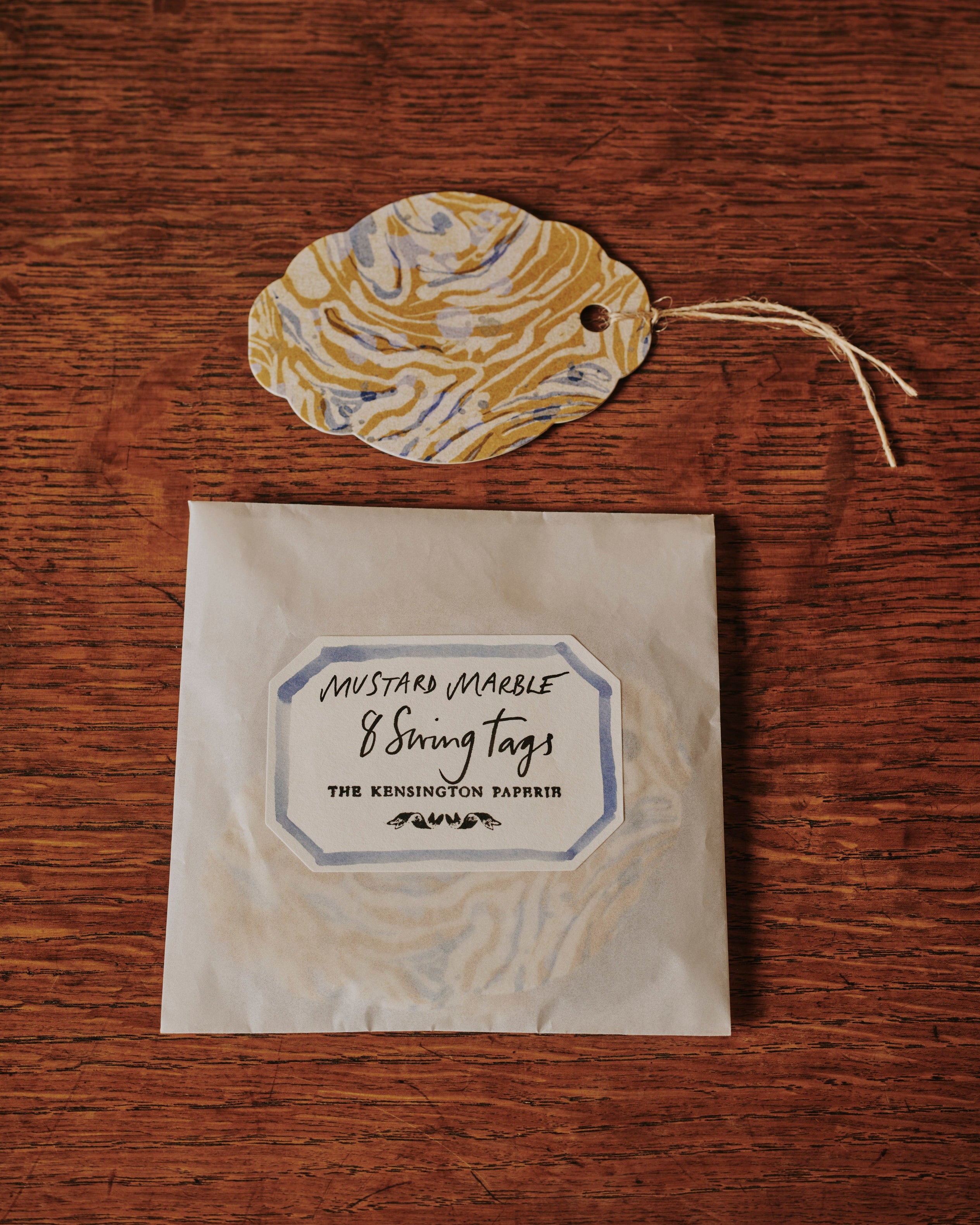 A shot of The Kensington Paperie marble mustard swing tag