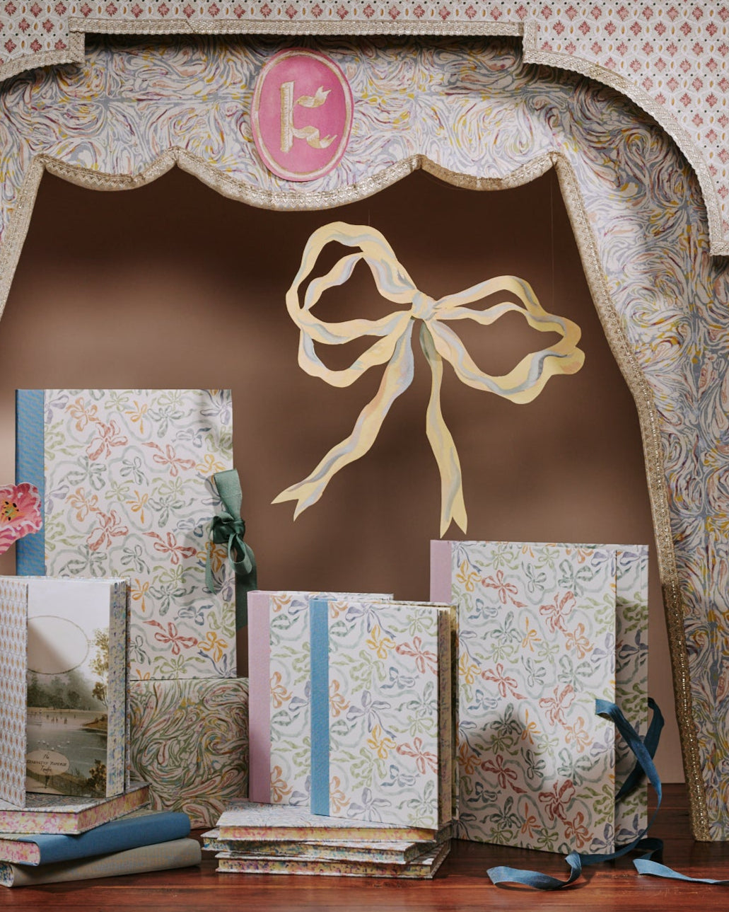 Decorative stationery items with ribbons and a decorative arch in the background
